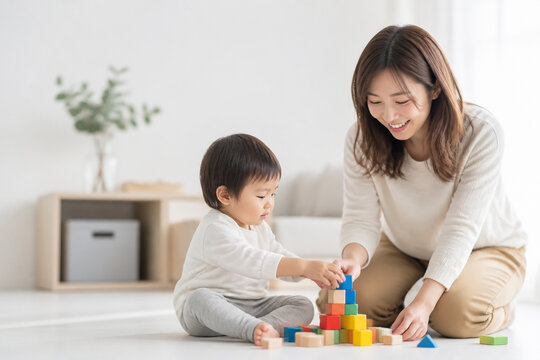 リビングで積み木遊びをする母親と子供