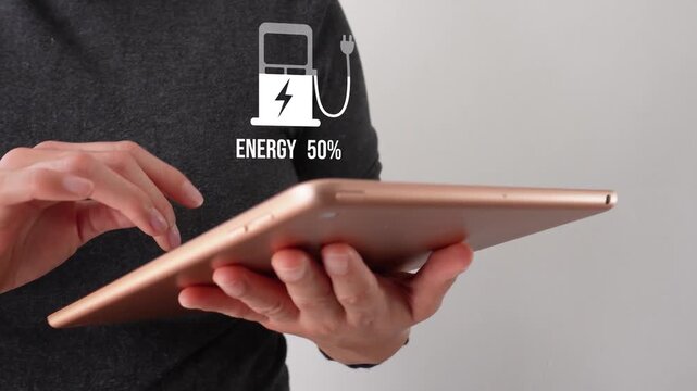 Close-up of a businesswoman interacting with her tablet, featuring a power icon above a stylized electric pump that displays a fill level and a percentage.