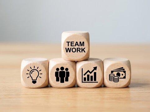 Wooden cubes stacked with business icons and teamwork text ideal for corporate marketing symbolizing strategy collaboration and financial growth