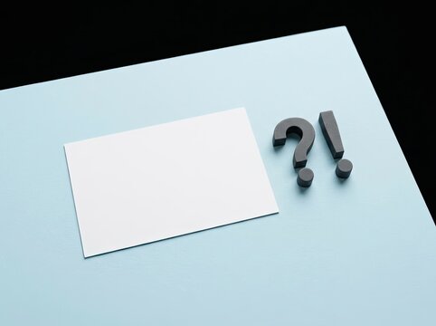 Blank card with question and exclamation marks on blue paper suitable for corporate design symbolizing problem solving inquiry and solutions