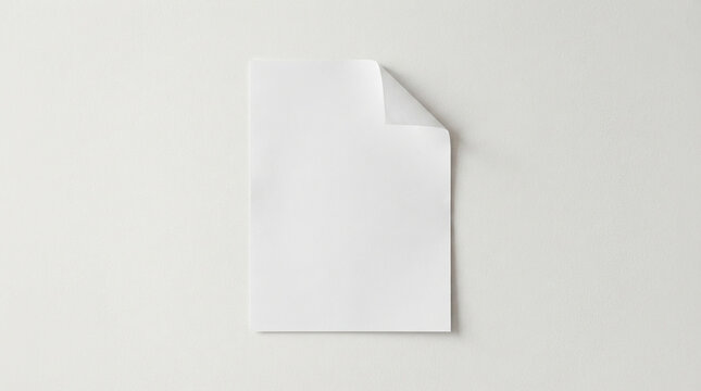 Blank A4 paper with curled corner on plain light gray background