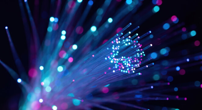 Colorful glowing fiber optics transmitting digital data signals