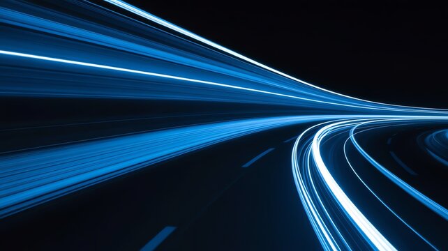 Abstract blue light trails motion blur on dark highway background representing fiber optics and speed
