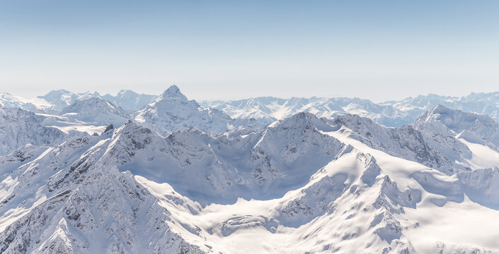 Panorama of winter Mountains with blue sky, snowy landscape