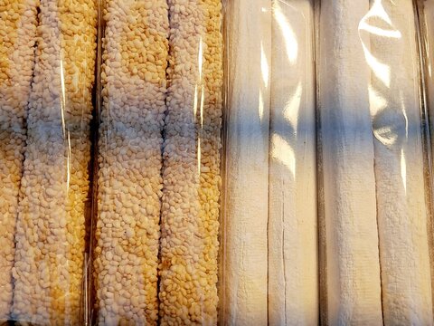 Traditional Korean taffy stick Yeot - Perilla taffy with sesame seeds and pumpkin taffy in Korean culture its sticky texture symbolizes the wish for the student to "stick" to a passing grade