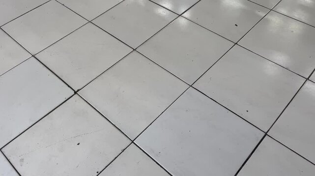 Wide angle perspective of white ceramic tile floor texture background