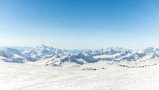 Panorama of winter Mountains with blue sky and snowy landscape