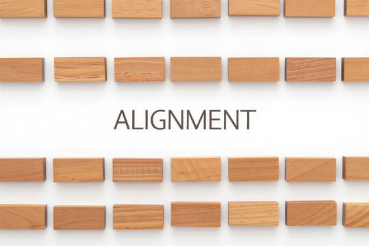 Wooden blocks arranged in perfect rows with the word Alignment on a white background