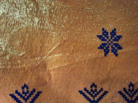 Orange color songket fabric with pattern
