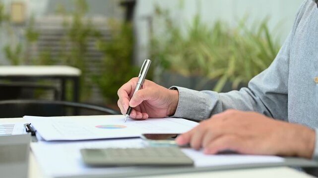 Businessman conducts financial planning outdoors, executing strategic planning near investment documents before completing corporate planning regarding investment report data.