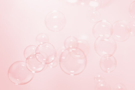 Clear Soap Bubbles Floating in The Air. Celebration Festive Backdrop. Freshness Soap Suds Bubbles Water. Blue, Pink and White Gradient Blurred Background.	
