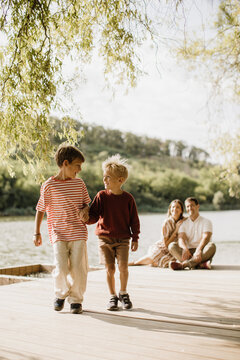 Joyful moments of friendship by the lake during a sunny afternoon
