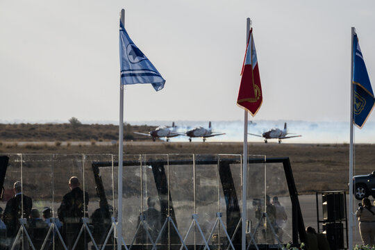 A group of Israeli generals and politicians gather to watch the display of their latest war machines