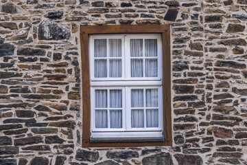 Fototapeta premium White-Paned Window in Rustic Stone Wall