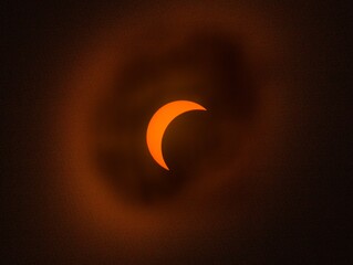 Solar eclipse with a glowing crescent sun partially obscured by the moon © IMRAN_IM33