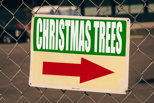 Christmas trees sign on fence