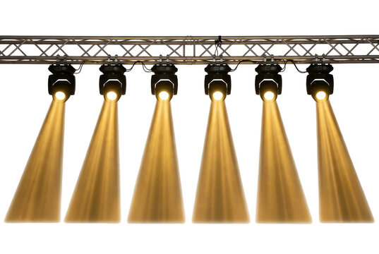 Stage lights mounted on a metallic truss casting warm beams in darkness