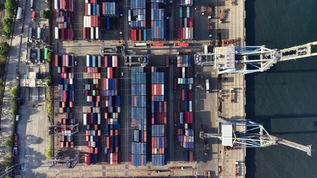 Shipping containers and docking cranes at container terminal India harbour cargo freight logistics