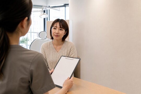 Staff explaining a treatment plan to a patient at a clinic