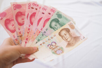 China currency , Many yuan bank notes Placed on the table. The yuan is the currency of china that is used to change, buy, sell, accumulate, and invest in china stock. © Shisu_ka