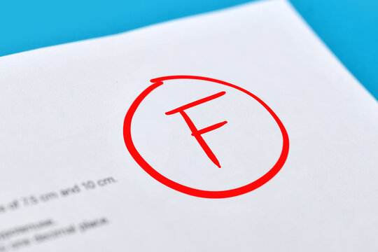 F grade marked in red on a school exam paper symbolizing academic failure