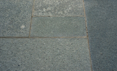 Fototapeta premium Dark stone tiles arranged in a grid pattern