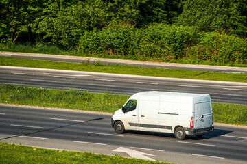 Logistics vehicle on peaceful rural highway © AlexGo