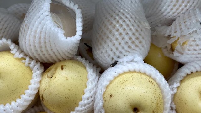 Fresh Yellow Pears Piled with Foam Net Protectors