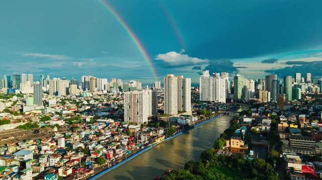 Bright double rainbow arcs above Pasig River and dense Metro Manila skyline