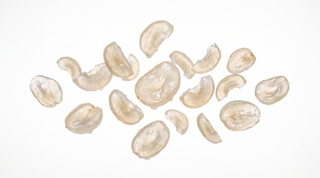 Peeled longan fruit slices floating on white background