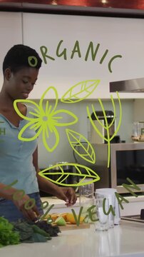 Animation of organic, 100 percent vegan, raw, fresh text, african american woman making juice