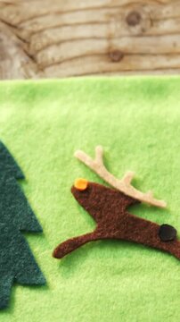 Animation of decorations on wooden background at christmas