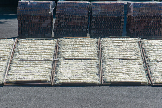 Traditional Chu rice noodles arranged on bamboo drying racks under sunlight in Vietnam, showcasing handmade noodle production and a traditional natural drying process.