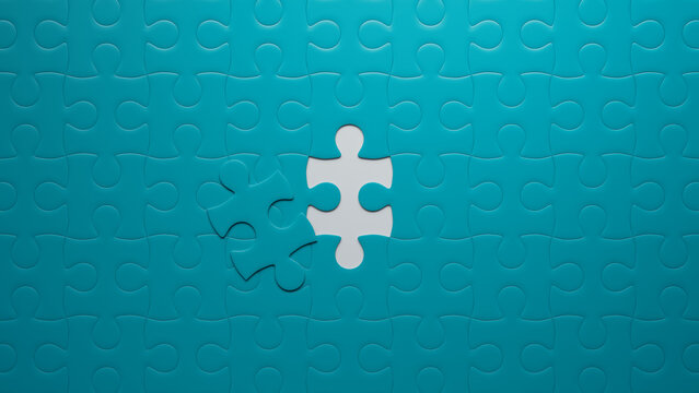 Teal and White Jigsaw Puzzle Background focusing on the last piece to go into place. Goal Concept.