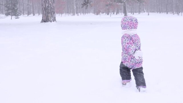 Toddler running winter. Active child running in snow in winter forest.