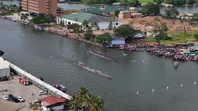 Cinematic slow-motion footage of wooden oars striking the water in unison during the intense Nehru Trophy Boat Race in Kerala, India. Captures the physical exertion, teamwork, and cultural pride of th