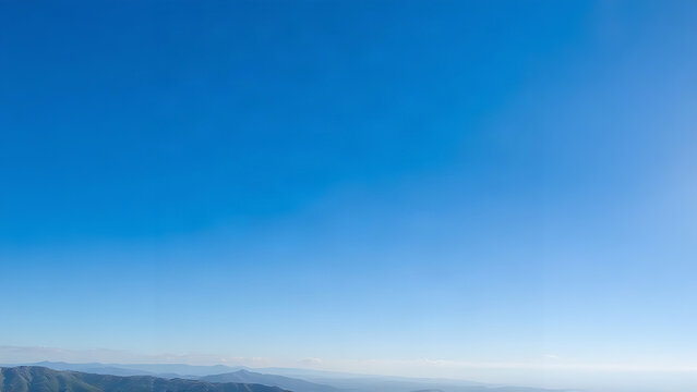 Deep blue autumn sky above distant mountains, clear and serene.