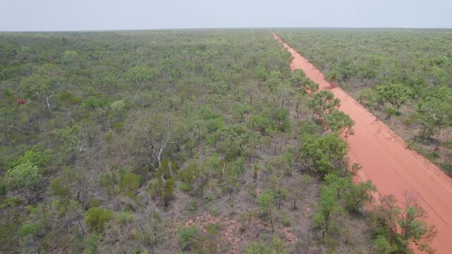 Aerial View Of Red Pindan Landscape - Red Dirt Road Through A Dense Green Bushland In Dampier Peninsula, Western Australia.