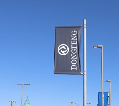 Tavagnacco, Italy. September 3, 2026. Dongfeng banner flag by the official car dealership against blue sky. Donfeng motor corporation is a chinese automobile manufacturer.
