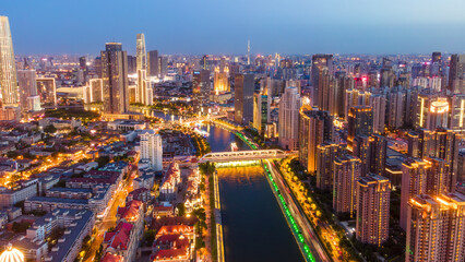 Fototapeta premium Twilight Cityscape with River and Modern Bridges