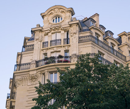 Paris Haussmann building facade featuring ornate details, balconies, and dormer windows