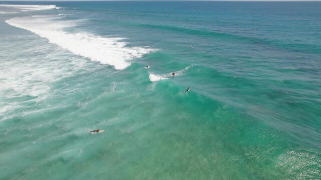 Red Bluff Surfers Riding Turquoise Ocean Waves Over Coral Reef In Western Australia - Aerial