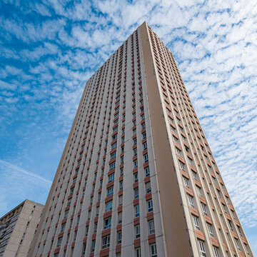 Les Olympiades residential high rise building with a cloudy blue sky background