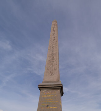 Luxor Obelisk with hieroglyphics against a blue sky representing history and travel