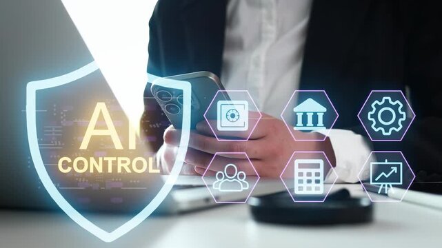 A person is using a smartphone while seated at a desk in an office. The background shows a computer with graphics related to AI control. Tools and icons indicate management tasks.