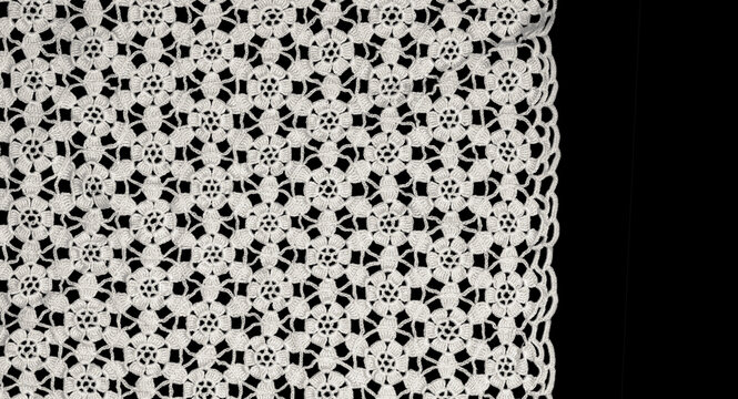 Crochet lace patterns border, crocheted Grandma's Doily, detail of hand-crocheted embroidery, tablecloth, napkin isolated on black background border art design. Craft, vintage linen. Flat lay 