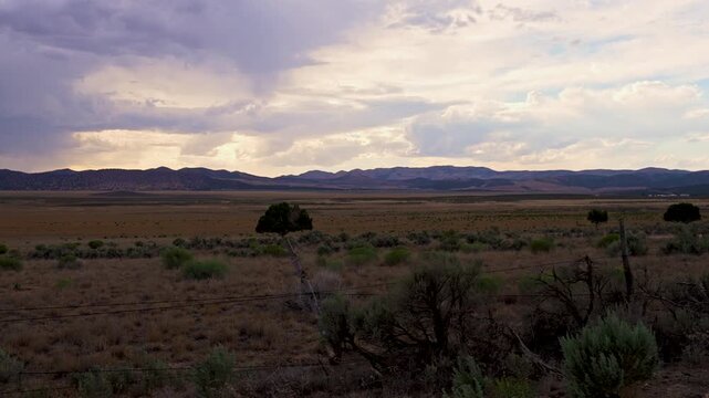 View from moving vehicle looking over the Utah desert in the summer during sunset.