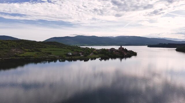 Drone view of "Uribarri Ganboa" village surronded by a reservoir with the same name in Araba, at the Basque Country.