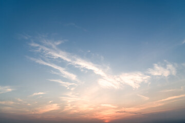 Fototapeta premium Soft Cirrus Clouds at Sunset Over Clear Blue Sky