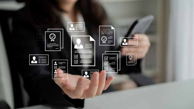 Professional recruitment process with digital documents and resumes in a business setting showcasing modern hiring technology. Entropy.